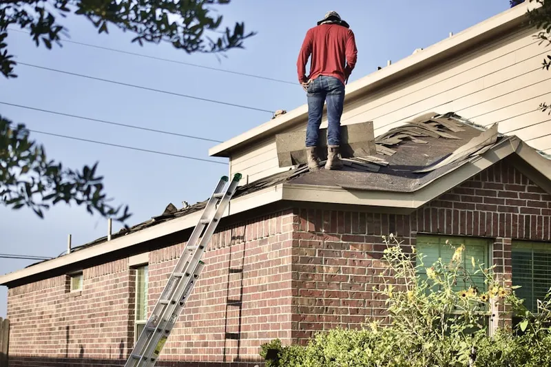 Professional roofer working on a residential roof in Carey